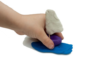 plasticine boat in children's hands on a white background. isolate. close-up.