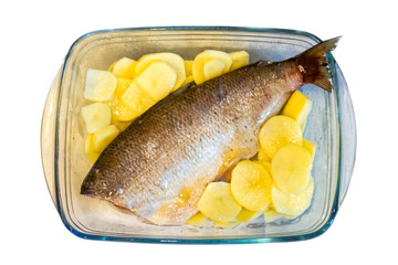 carved and prepared for baking fish in a transparent glass form for the oven, whitefish,...