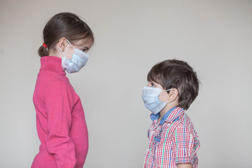 brother and sister in a medical mask during the coronavirus pandemic