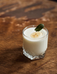 Yogurt with nuts on a wooden light background. Natural yogurt. View from above. Summer food.