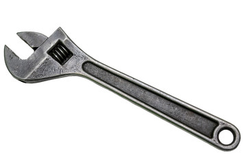Large adjustable wrench on a white background. Insulated object. Old worn tool for mechanic. Metal texture close-up.