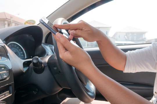 Cropped Hands Of Man Using Global Positioning System While Driving Car