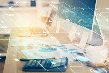 Double exposure of desktop computer and technology theme hologram. Concept of software development.