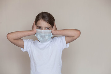 a young girl in a medical mask during the days of the coronavirus pandemic