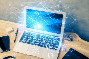 Double exposure of desktop computer and technology theme hologram. Concept of software development.