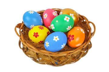 Fototapeta na wymiar Colorful painted Easter eggs in the basket reflecting on the white background,