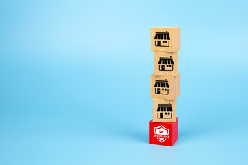 Franchise marketing icons Store on cube wooden toy blog is stacked with insurance icon base. Concepts risk Management and stable financial structures.