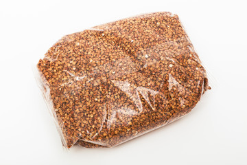 buckwheat in transparent bag on white background