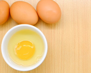 Close-up view of raw chicken eggs on background