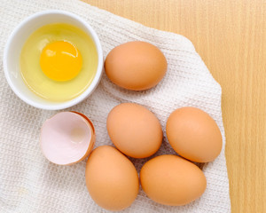 Close-up view of raw chicken eggs on background