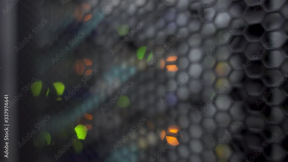 Poster honeycomb pattern doors inside modern big data server rack in the data center. blurred background.