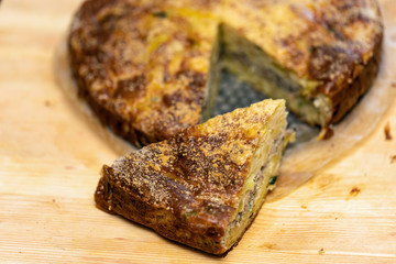 Homemade yeast-free cake on kefir with a filling of canned fish and potatoes, close-up.