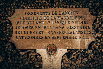 underground catacombs full of bones, gravestones and inscriptions