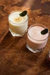 Yogurt with nuts on a wooden background. Side view. Summer food.