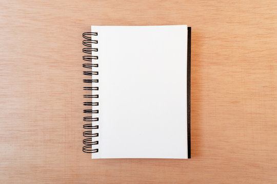 Blank notebook, ring binder, in a cork background. Flat lay, copy space, top down perspective
