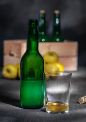 Asturian cider glass apples wooden crate with bottles on black background