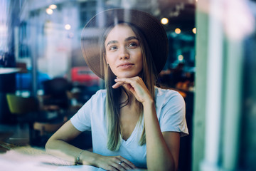 Pensive lady reading book in cafe