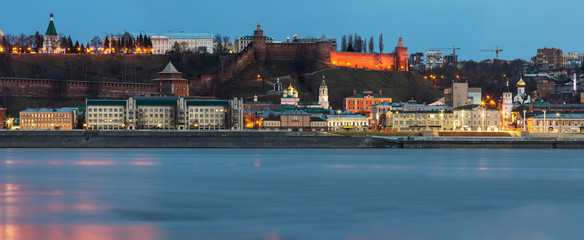 A unique perspective of Nizhny Novgorod in the evening with the city lights on against the backdrop of a beautiful sky and sunset