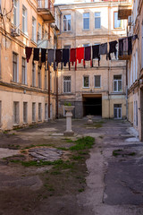 The courtyard of old city have been washed clean clothes and bed linen hanging out to dry between old houses and trees on tight rope. dries clothes on a rope