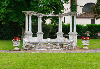 Fototapeta na wymiar Pavilion in garden, stone ancient arbor in Italy