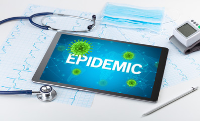 Close-up view of a tablet pc with EPIDEMIC inscription, microbiology concept