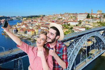 Happy, young couple taking a self portrait photo, selfie in the in Porto, Portugal