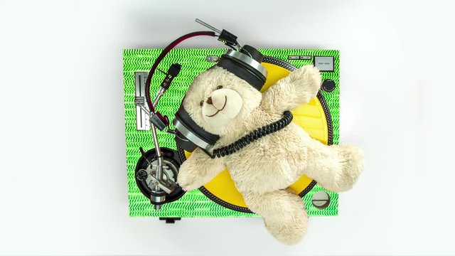 a dj teddy bear on turntables