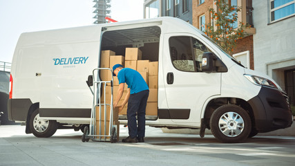 Fototapeta Courier Takes out Cardboard Box Package From Opened Delivery Van Side Door. Professional Courier / Loader helping you Move, Delivering Your Purchased Items Efficiently obraz