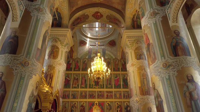 Inside interior of church monastery of Sviyazhsk religious Orthodox center on island. Icons painted murals. Faith religion Tatarstan russia. Beautiful icons drawings of saints martyrs. Gimbal upwards