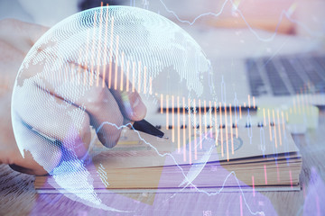 Multi exposure closeup hands with stock market forex graph.