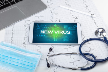 Tablet pc and doctor tools with NEW VIRUS inscription, coronavirus concept