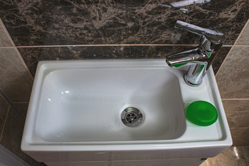 A sink with green soap bar