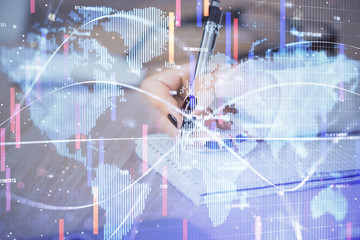 International business hologram over hands taking notes background. Concept of success. Multi...