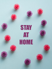 Coronavirus plastic models with inscription Stay at home. Sars-cov-2 pandemic concept COVID-19 pandemic concept 