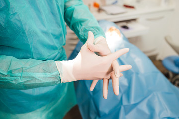 Surgeon putting on gloves before operation