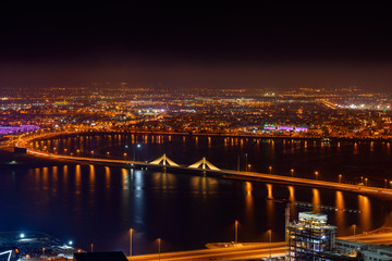Aerial View of Sheikh Isa bin Salman Causeway Bridge also known as Muharraq Bridge and Muharraq City at night, Manama, Bahrain.