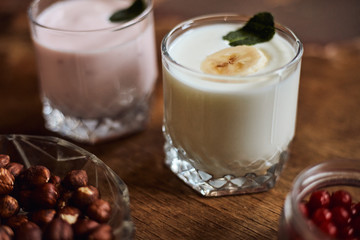 Yogurt with nuts on a wooden background. Side view. Summer food.