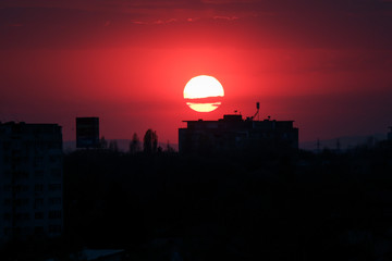 Fototapeta premium Beautiful sunset above the city skyline , The city of Ploiesti, Romania with a beautiful sun
