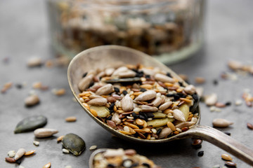 Healthy seeds mix in a wooden spoon close up. Healthy foods, vegan food ingredient.