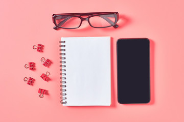 Workplace with stationery accessories on pink countertop. Business or back to school concept. Secretaries workspace © OlekStock