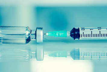 Medication drug needle syringe drug, .Syringe and vaccine front of a laboratory scene