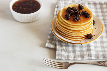 stack of sweet  pancakes  with fir cone jam on white background.