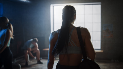 Shot of the Beautiful Athletic Woman Walking into Hardcore Gym. Ready for Her Power Workout, Strength Exercise and Bodybuilding Training Session.