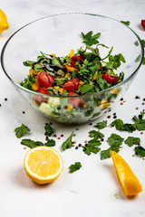 Healthy diet food. Fitness salad from different fresh greens , tomatoes, peppers, avocados, cucumbers with olive oil and balsamic sauce