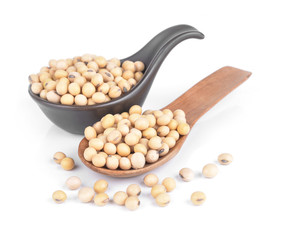 Soy beans on a wooden spoon isolated on a white background