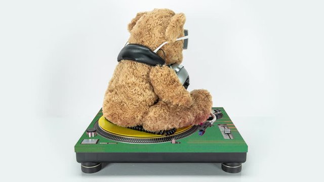 a dj teddy bear on turntables