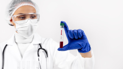 Scientist doctor holding positive blood test tube sample for coronavirus. Coronavirus outbreak and pandemic concept.