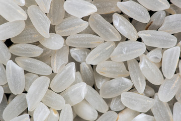 rice and round grain peeled seeds on a black background top view