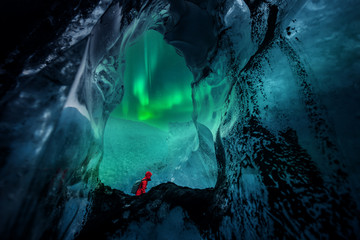 Northern lights aurora borealis over glacier ice cave.
