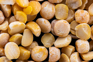 halves of dried crushed pea seeds on a black background